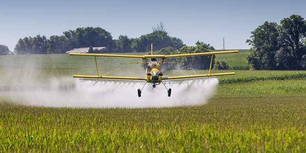 A plane applying a pesticide application